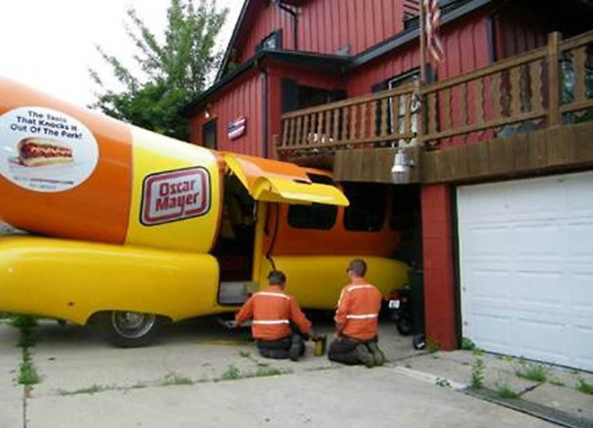 ORG XMIT: WIRAC101 An Oscar Meyer Wienermobile crashed into the home and outdoor deck of Nick Krupp in Racine, Wis. on Friday morning, July 17, 2009. According to a witness, the vehicle was parked in the driveway. The driver lurched the vehicle forward instead of backing out of the driveway, hitting Krupp's deck and cracking the foundation of his house. (AP Photo/Journal Times, Tom McCauley)